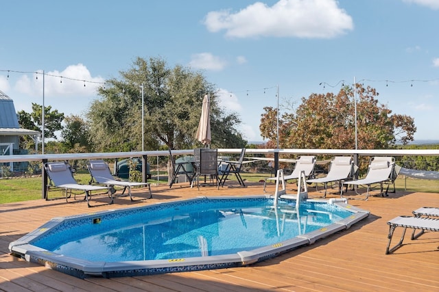 view of swimming pool featuring a deck