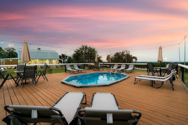 pool at dusk with a deck