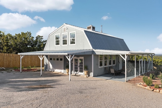 view of front of home featuring french doors, a patio, a garage, and a carport