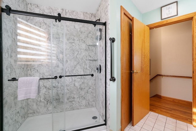 bathroom with hardwood / wood-style floors and a shower with door