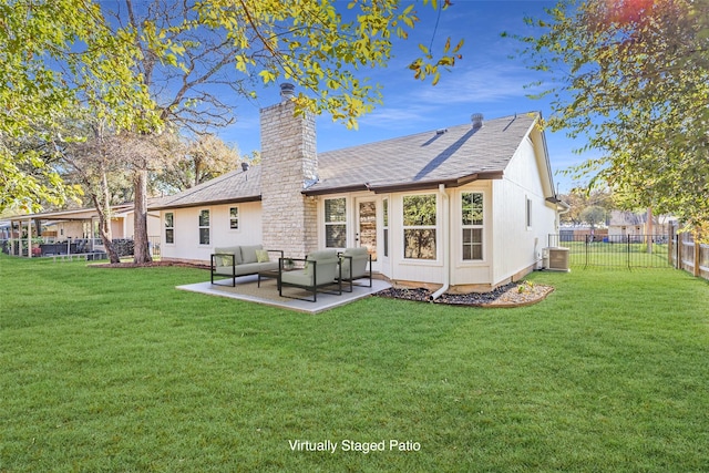 back of property with a patio, central AC unit, and a lawn