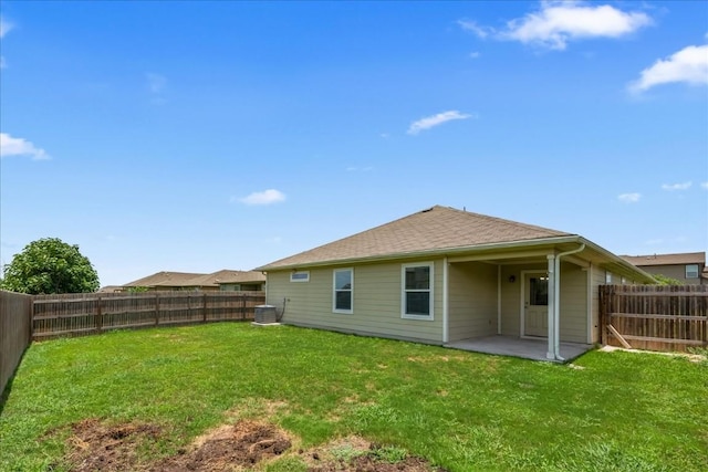 back of property featuring a lawn, central air condition unit, and a patio