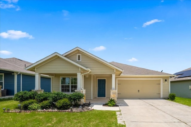 craftsman inspired home featuring an attached garage, driveway, a shingled roof, and a front yard