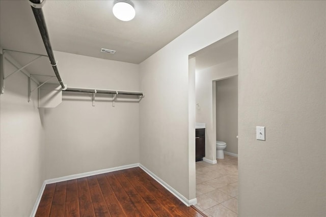 spacious closet featuring hardwood / wood-style floors