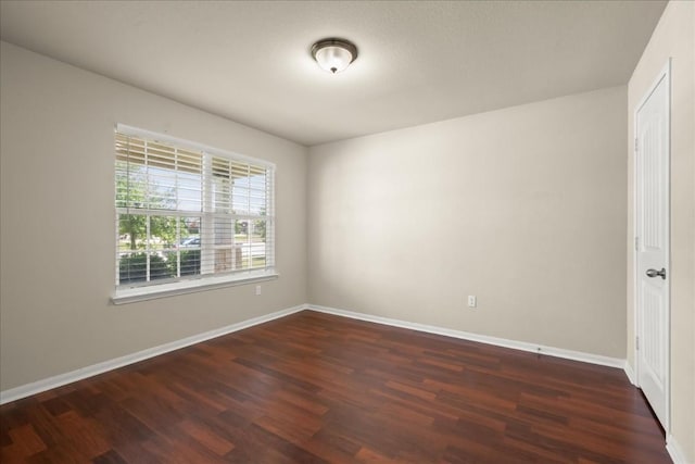 spare room featuring dark wood-type flooring