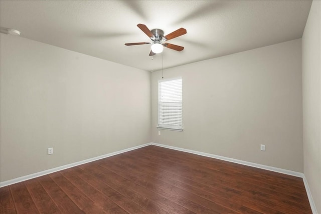 spare room with dark hardwood / wood-style floors and ceiling fan