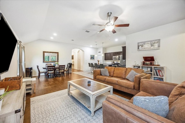 living room with light wood-type flooring, vaulted ceiling, and ceiling fan