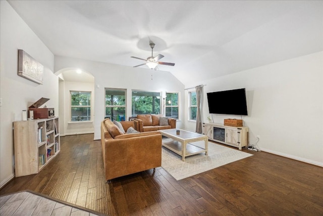 living room featuring ceiling fan, lofted ceiling, and dark wood-type flooring