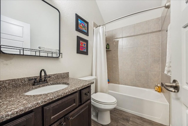 full bathroom featuring vanity, vaulted ceiling, toilet, shower / tub combo with curtain, and wood-type flooring