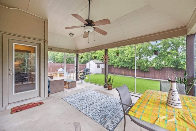 view of patio / terrace with an outdoor living space, a storage unit, and ceiling fan