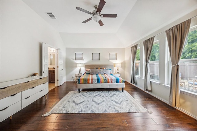 bedroom featuring ceiling fan, dark hardwood / wood-style floors, connected bathroom, and vaulted ceiling