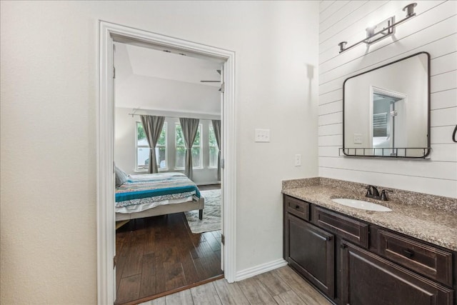 bathroom featuring wood-type flooring, vanity, and ceiling fan