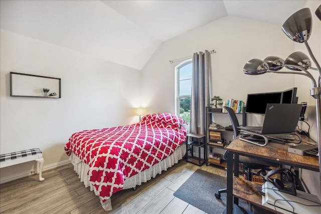 bedroom featuring hardwood / wood-style floors and lofted ceiling