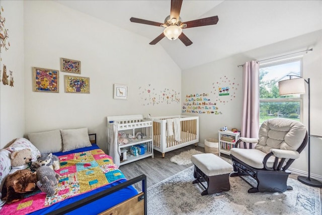 bedroom featuring hardwood / wood-style flooring, vaulted ceiling, and ceiling fan