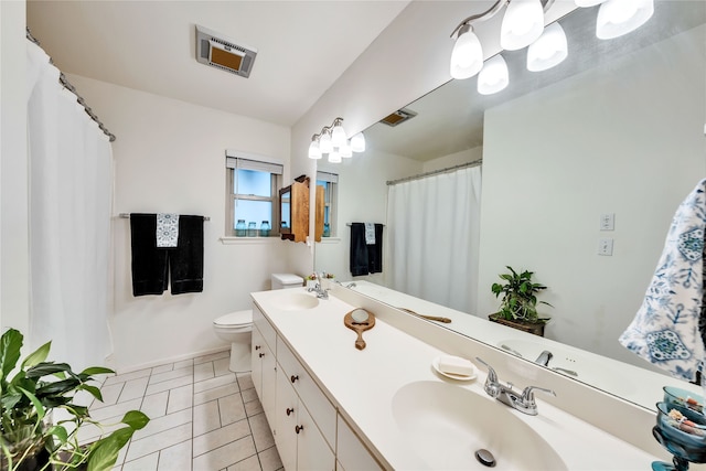 bathroom with vanity, tile patterned floors, and toilet