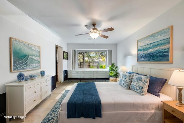 bedroom with ceiling fan and light tile patterned flooring