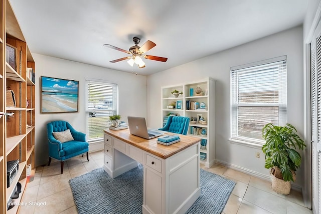 tiled office space featuring ceiling fan