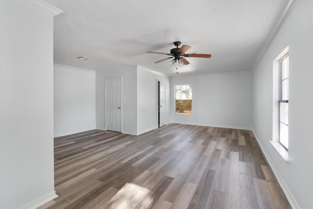 unfurnished room with ornamental molding and hardwood / wood-style flooring