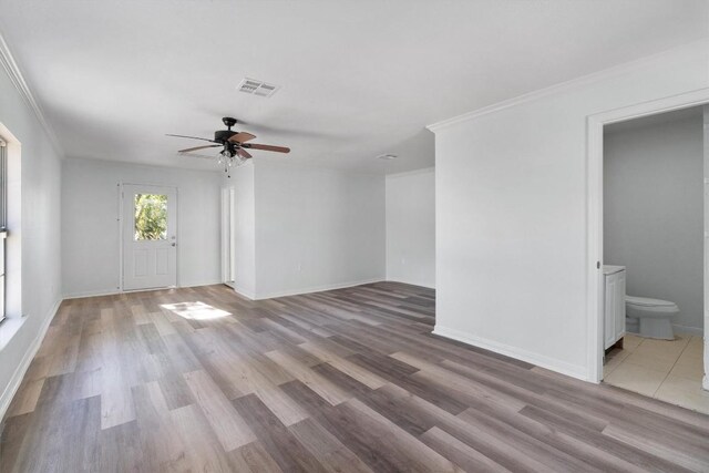 unfurnished living room with light hardwood / wood-style flooring, ceiling fan, and ornamental molding