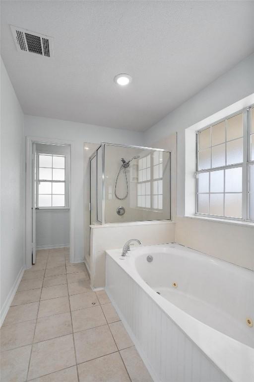 bathroom with tile patterned floors and plus walk in shower