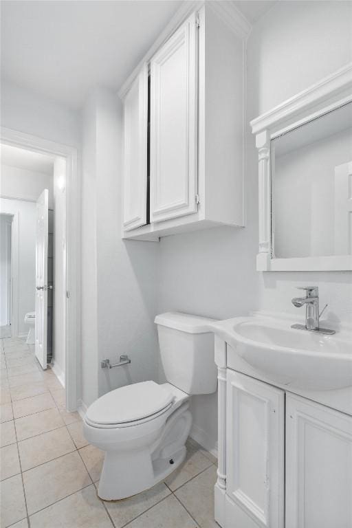 bathroom featuring tile patterned flooring, vanity, and toilet