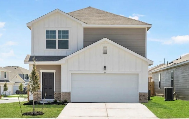 view of front facade featuring central AC unit, a garage, and a front yard