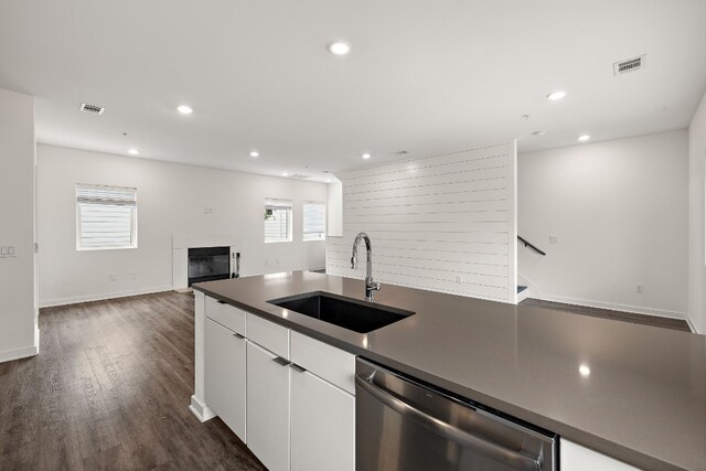 kitchen with white cabinetry, dishwasher, sink, and dark hardwood / wood-style flooring