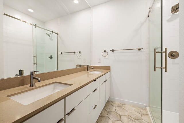 bathroom featuring vanity, tile patterned floors, and walk in shower