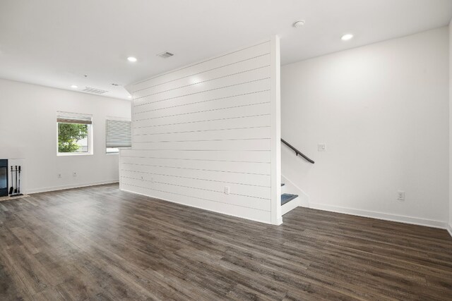 unfurnished living room with dark wood-type flooring