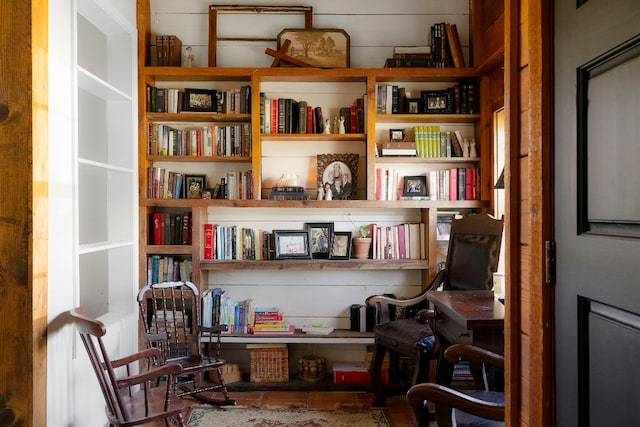 sitting room featuring wooden walls