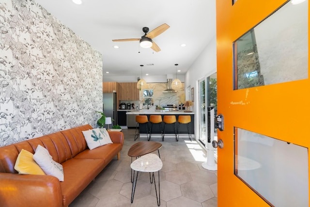 living room with ceiling fan and light tile patterned floors