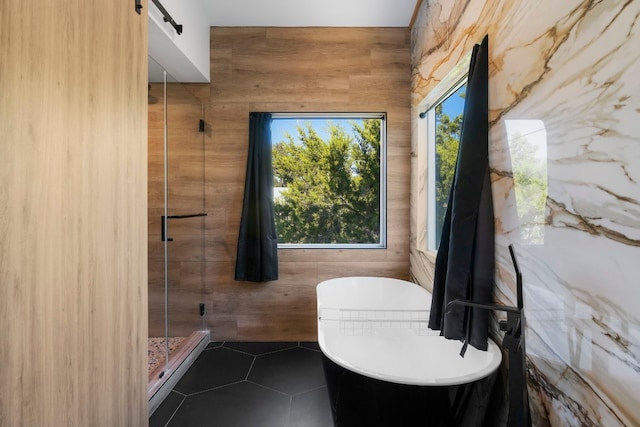 bathroom with tile patterned flooring and plus walk in shower