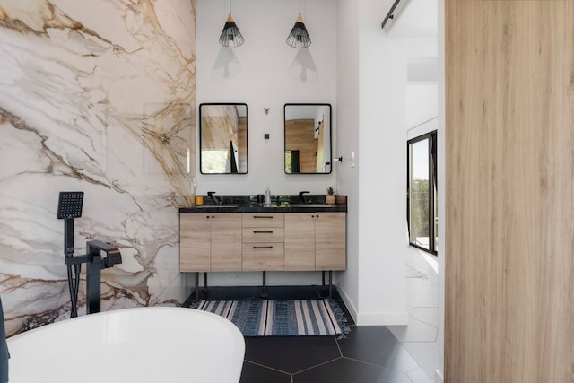 bathroom featuring tile walls, tile patterned flooring, vanity, and a bath