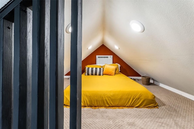 carpeted bedroom featuring a wall mounted air conditioner, lofted ceiling, and a textured ceiling