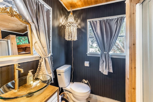 bathroom with wooden walls, wooden ceiling, and toilet