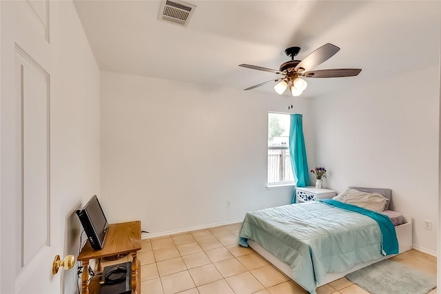 tiled bedroom featuring ceiling fan