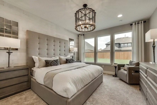 carpeted bedroom with a chandelier