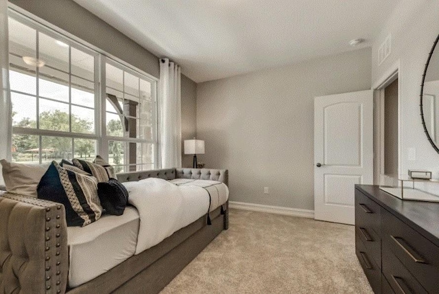 bedroom featuring light carpet