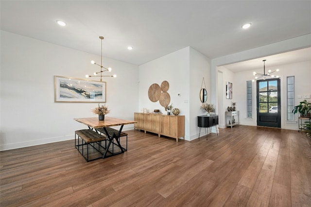 dining room featuring dark wood-type flooring and a chandelier