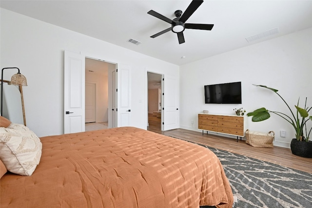 bedroom with ceiling fan and wood-type flooring