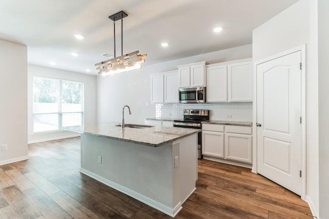 kitchen with white cabinets, sink, wood-type flooring, and stainless steel appliances