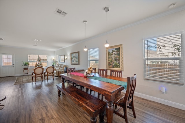 dining room featuring crown molding and dark wood-type flooring