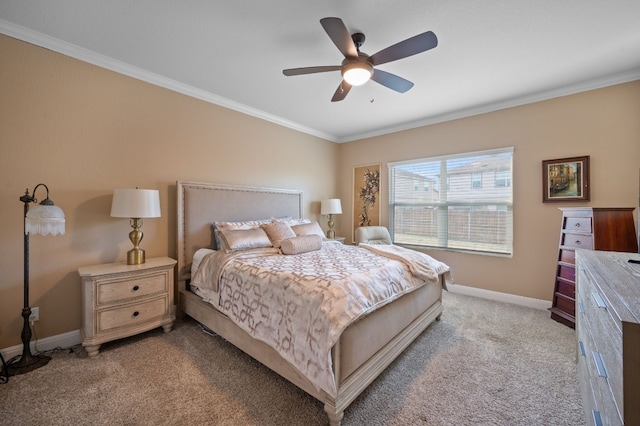 carpeted bedroom with ceiling fan and crown molding