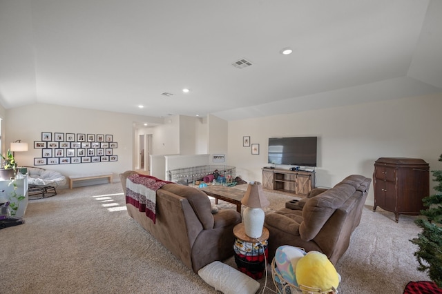 carpeted living room with vaulted ceiling