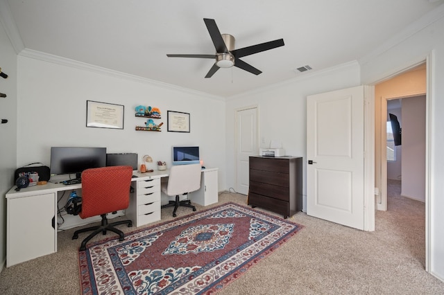 carpeted office space featuring ceiling fan and crown molding