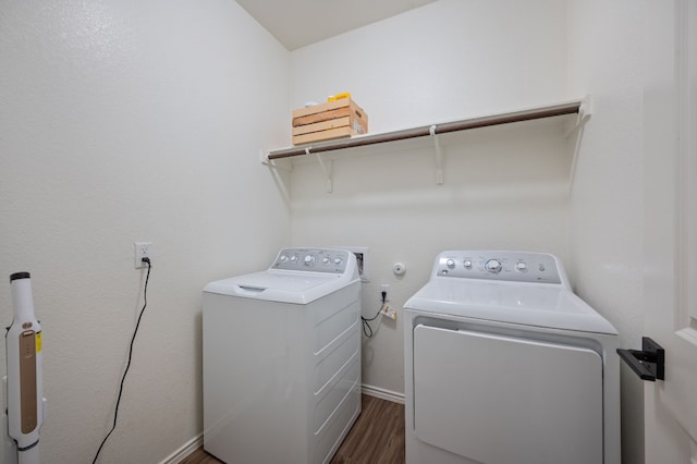 washroom with dark hardwood / wood-style flooring and washer and clothes dryer