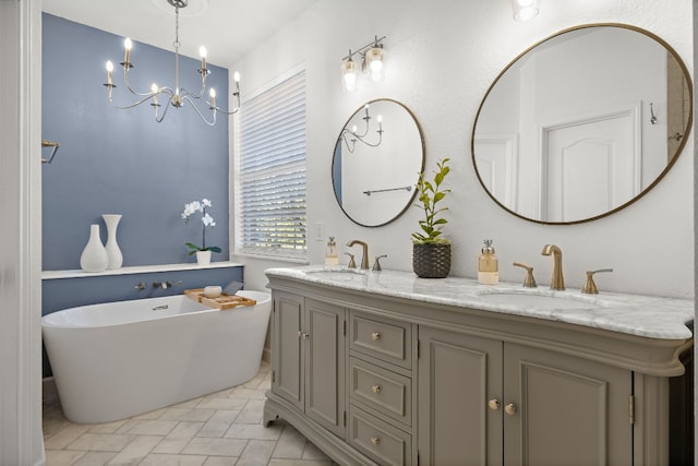 bathroom with a bathtub, vanity, and a notable chandelier