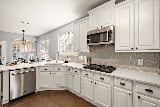 kitchen featuring white cabinetry, sink, dark hardwood / wood-style floors, and appliances with stainless steel finishes