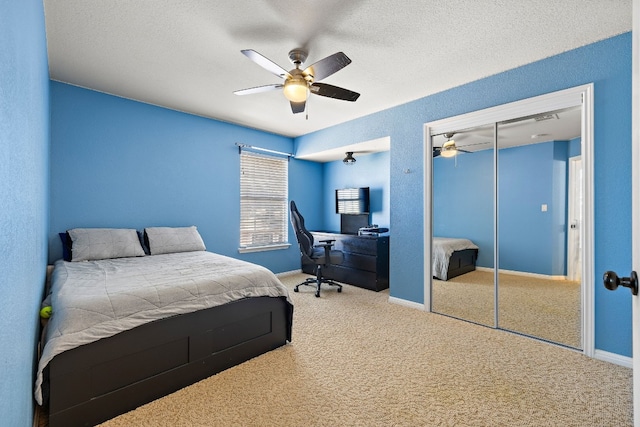 carpeted bedroom with a textured ceiling and ceiling fan