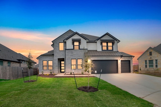 modern inspired farmhouse with a garage and a lawn